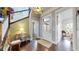 Charming foyer with hardwood floors, designer wallpaper, complemented by a vintage chest and stairway at 9437 E 51St Dr, Denver, CO 80238
