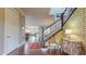 Open foyer with hardwood floors, designer wallpaper, and an inviting entryway leading to the living spaces at 9437 E 51St Dr, Denver, CO 80238
