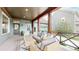 Inviting front porch featuring comfortable seating, wood beams and railings, creating an ideal outdoor relaxation space at 9437 E 51St Dr, Denver, CO 80238