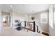 Bright hallway featuring neutral walls, a work space, and stairs with decorative chandelier at 9437 E 51St Dr, Denver, CO 80238