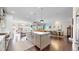 Open-concept kitchen with a large island, stainless steel appliances, and hardwood floors at 9437 E 51St Dr, Denver, CO 80238