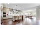 Bright and open kitchen with a center island, stainless steel appliances, and hardwood floors at 9437 E 51St Dr, Denver, CO 80238