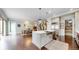 Modern kitchen with center island, stainless steel appliances, and hardwood floors at 9437 E 51St Dr, Denver, CO 80238
