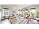 Elegant living room featuring hardwood floors, large windows, and stylish decor at 9437 E 51St Dr, Denver, CO 80238