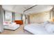 Comfortable main bedroom offering tray ceilings, ample natural light, and a cozy seating area at 9437 E 51St Dr, Denver, CO 80238