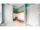 Stylish mudroom with white shiplap, wooden bench, and storage for shoes and coats at 9437 E 51St Dr, Denver, CO 80238