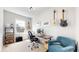Bright office space with large window, desk, guitars, and blue chair at 9437 E 51St Dr, Denver, CO 80238