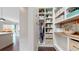 Well-organized pantry with custom shelving and storage solutions for efficient kitchen essentials at 9437 E 51St Dr, Denver, CO 80238