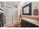 Bathroom with granite countertops, framed mirror and walk-in shower at 9938 Grove Way # B, Westminster, CO 80031