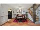 Bright dining room with modern chandelier, staircase, and dark wood flooring at 9938 Grove Way # B, Westminster, CO 80031