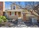 Close up of a home with a brick entryway, red shuttered window and manicured garden at 9938 Grove Way # B, Westminster, CO 80031