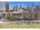 Inviting exterior featuring a prominent brick chimney, complemented by well-maintained landscaping at 9938 Grove Way # B, Westminster, CO 80031