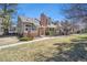 Charming townhome with a brick chimney, tidy landscaping, and a welcoming front porch at 9938 Grove Way # B, Westminster, CO 80031