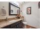 Stylish half bathroom with dark cabinets, granite countertop, and modern fixtures at 9938 Grove Way # B, Westminster, CO 80031