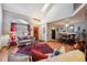 Open-concept living room with hardwood floors, vaulted ceiling, and dining area at 9938 Grove Way # B, Westminster, CO 80031