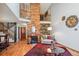 Inviting living room with a striking brick fireplace, hardwood floors, and cozy seating at 9938 Grove Way # B, Westminster, CO 80031