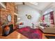 Vaulted ceiling living room featuring a brick fireplace, skylight, and stylish decor at 9938 Grove Way # B, Westminster, CO 80031