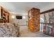 Cozy loft featuring a brick accent wall, comfortable seating, and carpeted floor at 9938 Grove Way # B, Westminster, CO 80031