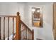 Elegant wooden staircase with decorative mirror and soft lighting at 9938 Grove Way # B, Westminster, CO 80031