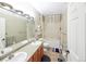 Bathroom features double sinks, large mirror, and tub with shower at 8481 W Union Ave # 2-201, Littleton, CO 80123