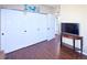 Bedroom featuring a closet, a mounted TV, and hardwood floors at 8481 W Union Ave # 2-201, Littleton, CO 80123