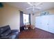 Bedroom with a sewing table in front of a window with floor-length curtains and a white ceiling fan and closet at 8481 W Union Ave # 2-201, Littleton, CO 80123