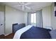 Bedroom with hardwood floors and featuring a bed, blue end tables, a window, and a dresser at 8481 W Union Ave # 2-201, Littleton, CO 80123