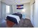 Bedroom featuring a window, hardwood floors, and a bed, blue end tables, ceiling fan and a closet at 8481 W Union Ave # 2-201, Littleton, CO 80123