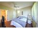 Comfortable bedroom boasts wood floors, ceiling fan, and access to bathroom at 8481 W Union Ave # 2-201, Littleton, CO 80123