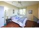 Cozy bedroom features wood floors, ceiling fan, and natural light from the window at 8481 W Union Ave # 2-201, Littleton, CO 80123