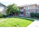 Exterior view of a multi-story apartment building featuring a well-maintained lawn at 8481 W Union Ave # 2-201, Littleton, CO 80123