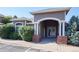 Clubhouse entrance featuring brick pillars and manicured landscaping at 8481 W Union Ave # 2-201, Littleton, CO 80123