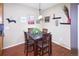 Cozy dining area with a wooden table, seating for four, and decorative wall art that brings charm at 8481 W Union Ave # 2-201, Littleton, CO 80123