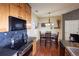 Cozy kitchen area featuring a dark countertop, wooden cabinets, and a dining area with a dark table and wooden chairs at 8481 W Union Ave # 2-201, Littleton, CO 80123