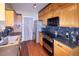 Well-lit kitchen with stainless steel appliances, wood cabinets, and sleek countertops. Perfect for cooking at 8481 W Union Ave # 2-201, Littleton, CO 80123