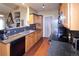 Modern kitchen featuring wood cabinets, sleek appliances, and stylish backsplash. Ideal for cooking and entertaining at 8481 W Union Ave # 2-201, Littleton, CO 80123