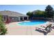 Community swimming pool with lounge chairs and shaded seating areas available to residents at 8481 W Union Ave # 2-201, Littleton, CO 80123