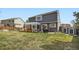Backyard featuring a well-maintained lawn, a hot tub on a patio, and a storage shed at 16442 Bluebonnet Dr, Parker, CO 80134