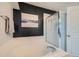 Bathroom with tiled walls, corner tub, and a shower with glass doors and a white door at 16442 Bluebonnet Dr, Parker, CO 80134