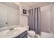 Neutral bathroom featuring tub with shower, gray shower curtain, single sink vanity, and modern fixtures at 16442 Bluebonnet Dr, Parker, CO 80134