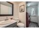 Half bath with modern fixtures, stylish vanity, and conveniently located laundry area at 16442 Bluebonnet Dr, Parker, CO 80134