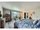 Bright bedroom featuring a large window, dresser, ensuite bathroom, and walk-in closet at 16442 Bluebonnet Dr, Parker, CO 80134