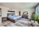 Spacious bedroom with light wood floors, walk-in closet, and ensuite bathroom, offering a relaxing retreat at 16442 Bluebonnet Dr, Parker, CO 80134