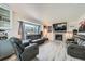 Cozy living room with a fireplace, comfortable seating, and a bright window at 16442 Bluebonnet Dr, Parker, CO 80134