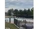 Community pool area with a splash pad, lounge chairs, shaded seating and mature trees in the background at 16442 Bluebonnet Dr, Parker, CO 80134