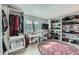 Organized walk-in closet, featuring ample storage, vanity area, shelving, and a round rug at 16442 Bluebonnet Dr, Parker, CO 80134