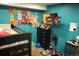 Well-organized bedroom showcasing a bunk bed, wall-mounted TV, and playful decorations, blending comfort and style at 14353 E 1St Dr # 201, Aurora, CO 80011