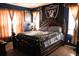 Spacious bedroom featuring dark blue walls, natural light, and a comfortable-looking king-size bed at 14353 E 1St Dr # 201, Aurora, CO 80011