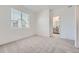 Bright bedroom featuring neutral carpet, crisp white walls and access to the bathroom at 27742 E 1St Ave, Aurora, CO 80018