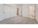 Bedroom featuring closet, white walls, neutral carpet, and bathroom access at 27742 E 1St Ave, Aurora, CO 80018